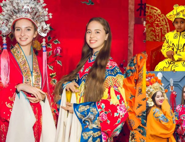 Audience member in elaborate Peking Opera costume and makeup posing for a souvenir photo at a theater